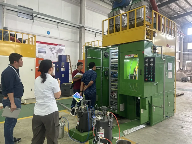 Thai customer conducting factory acceptance testing of Angem's automatic adhesive spray coating machine
